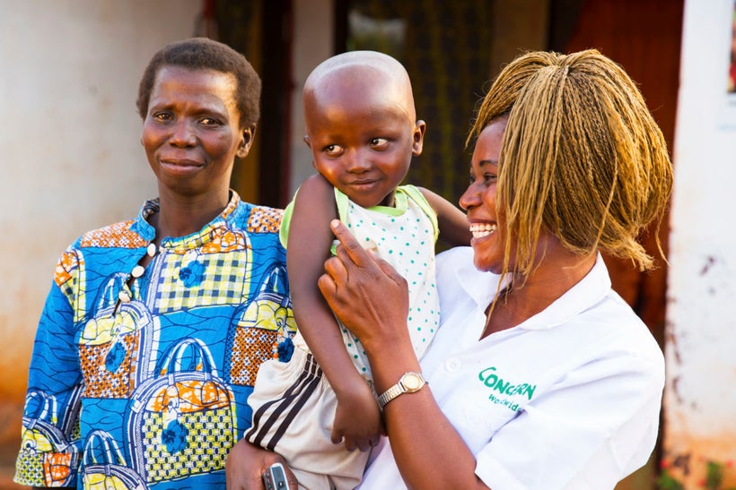 Concern Nutrition Officer Grekpengou Mathilde with five-year-old Mario Doutifed and his mother, Remadere Clemantine, at a Con