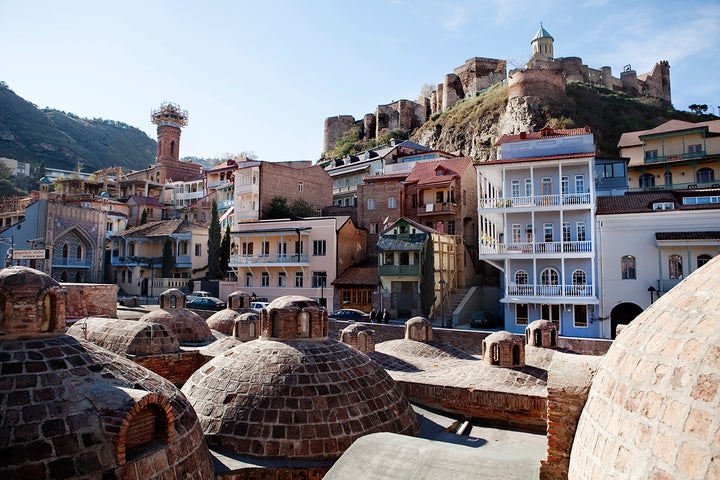 <p>Historic sulphur baths and carved wooden balconies in Tbilisi, Georgia</p>