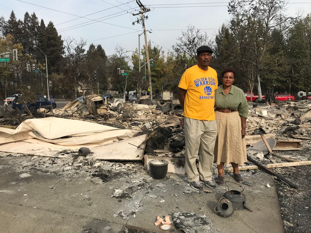 Marion Heim, right, and husband Lloid Heim stand on the ashes where their house used to be, in the days after the fire -- Oct. 2017, Santa Rosa, Calif.