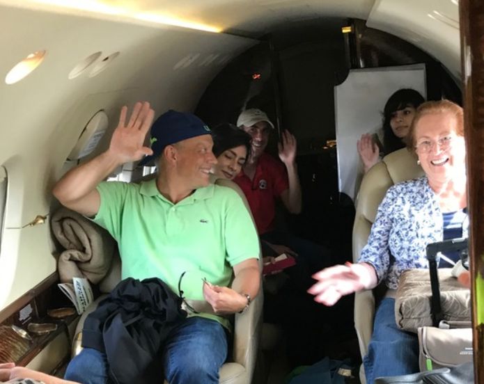 Sally (Right) on board the Eagles Wings jet heading to West Palm Beach with medical staff and other victims.
