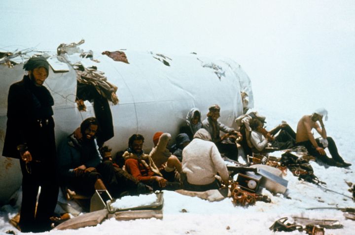 Survivors of the plane crash in the Andes pose for a picture in front of the plane's tail