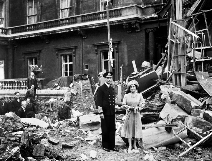King George VI and Queen Elizabeth stand amid the bomb damage to Buckingham Palace