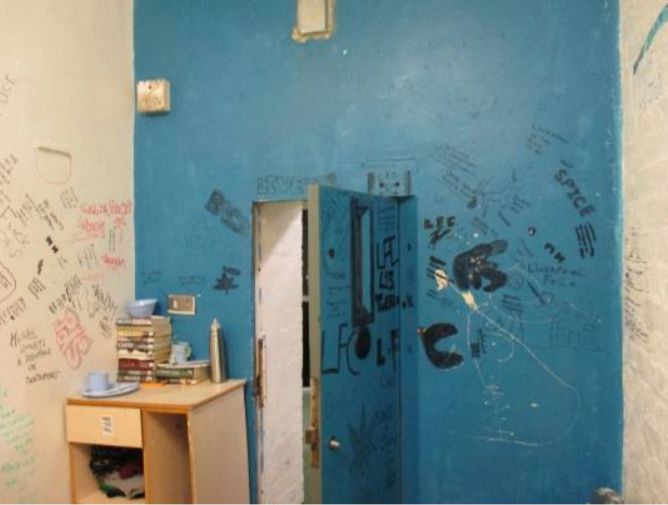 Graffiti and rubbish inside a cell at HMP Liverpool