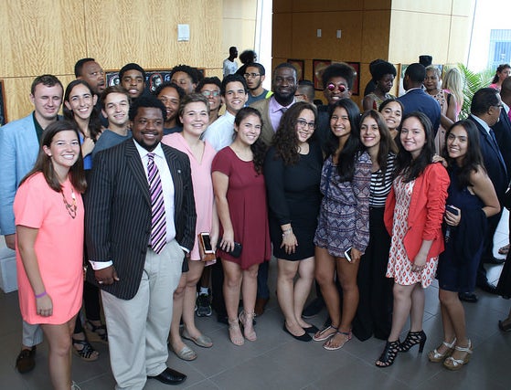 Justin Pinn being honored for his community building work. He is surrounded by Breakthrough Miami students.