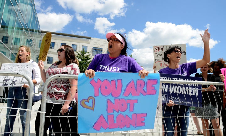 People protest Education Secretary Betsy DeVos' policy address on Title IX enforcement at George Mason University on Sept. 7.