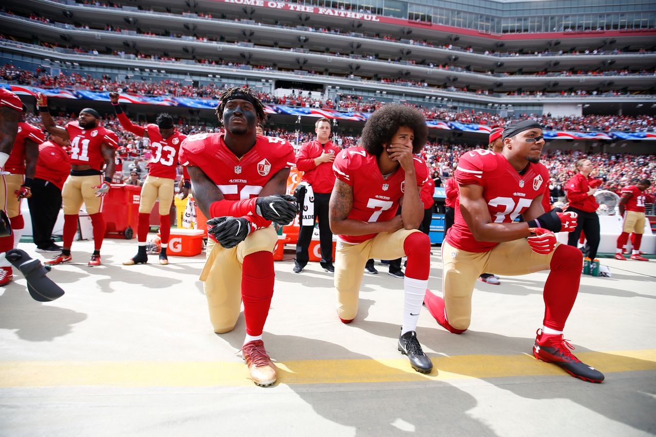Antoine Bethea and Rashard Robinson raise their fists during the national anthem as Eli Harold, left, Colin Kaepernick and Eric Reid take a knee prior to a game against the Dallas Cowboys on Oct. 2, 2016.