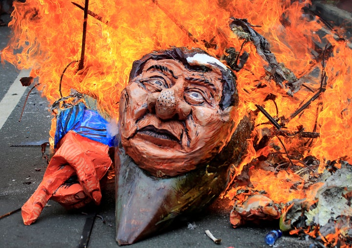 Protesters burn an effigy of Philippine President Rodrigo Duterte to express their outrage while calling for the immediate pullout of U.S. troops in Mindanao province.