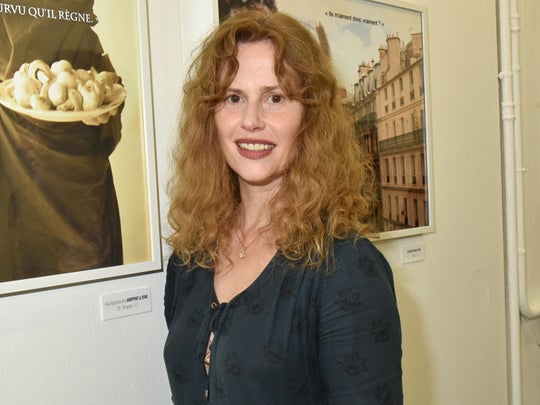 PARIS, FRANCE - JUNE 09:  Florence Darel poses with portraits of Stephanie Foenkinos travestite in politician women shot by Stephanie Murat during '55 Politiques' : Exhibition Preview at Galerie Dupin on June 9, 2016 in Paris, France.  (Photo by Foc Kan/WireImage)