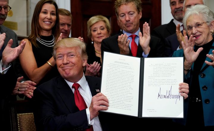 Trump celebrates after signing the Executive Order.