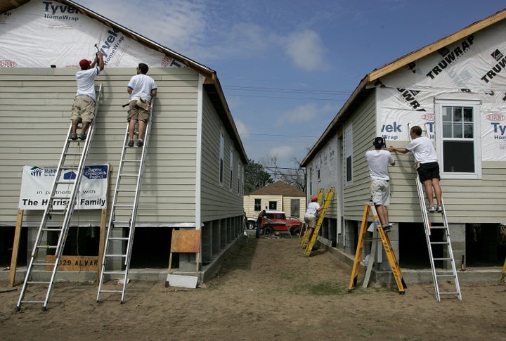 Volunteer construction workers with Habitat for Humanity build new homes August 23, 2006 in Upper Ninth Ward of New Orleans, Louisiana, as part of The Musicians' Village.