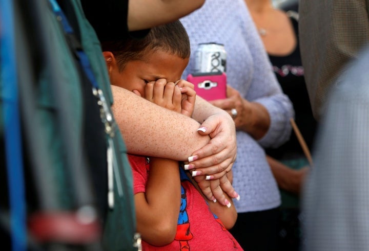 A 9-year-old boy attends a prayer vigil in honor of those affected by the shooting on the Las Vegas Strip.