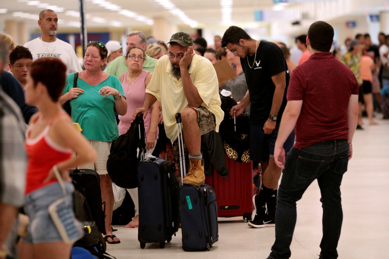 Stranded tourists and Puerto Ricans line up at the International Airport in San Juan on Sept. 25 as they try to leave after Hurricane Maria devastated power and communications across the island.