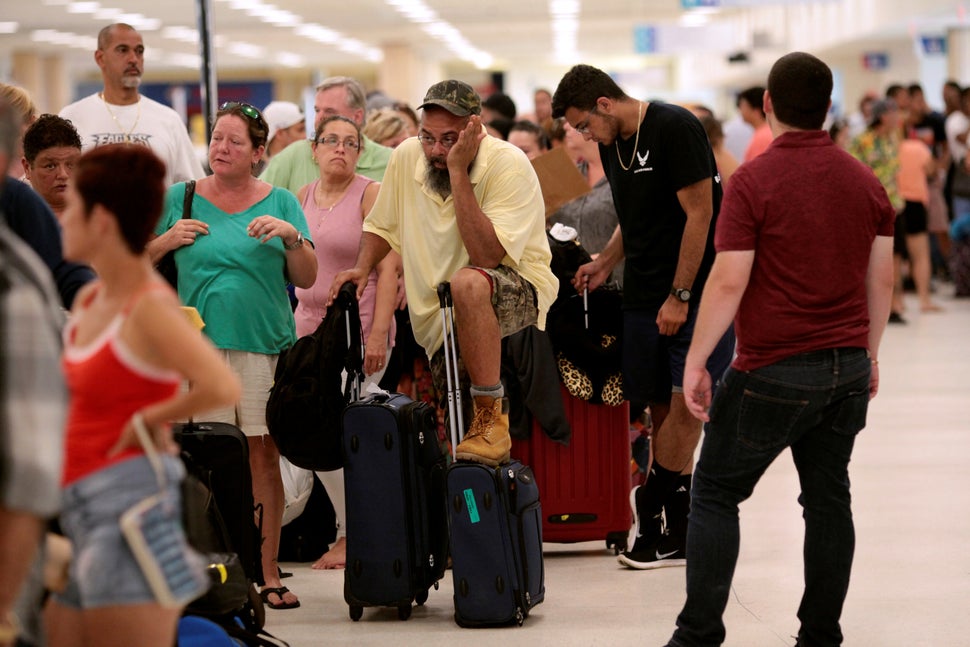 Stranded tourists and Puerto Ricans line up at the International Airport in San Juan on Sept. 25 as they try to leave after H
