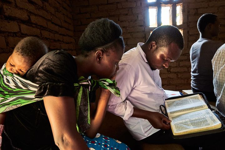 Jennifer and Wyclef read along with a sermon during a Sunday morning service at the Well of Life Church in Luchenza, southern Malawi, 2017.