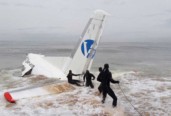 Rescuers pull the wreckage of a propeller-engine cargo plane after it crashed in the sea near the international airport in Ivory Coast's main city, Abidjan, on Oct. 14.