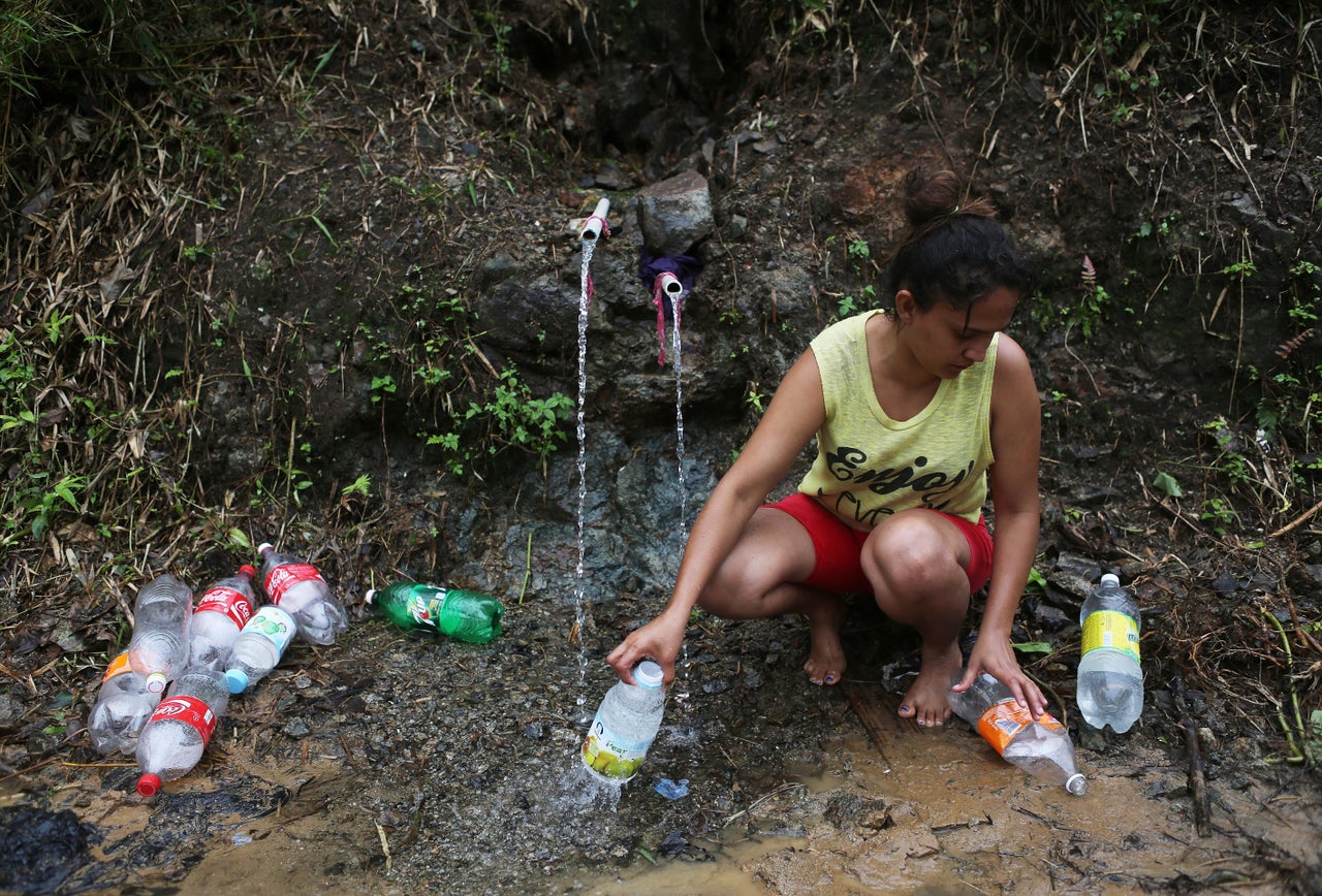 Yanira Rios collects spring water for use in her house last week in Utuado, Puerto Rico. Most of the municipality has been without running water or electricity since Hurricane Maria hit the island on Sept. 20.