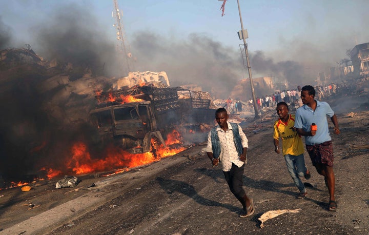 Civilians evacuate from the scene of an explosion in KM4 street in the Hodan district of Mogadishu, Somalia October 14, 2017.