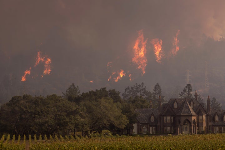 Flames rise behind Ledson Winery on October 14, 2017 in Kenwood, near Santa Rosa, California. (Photo by David McNew/Getty Images)