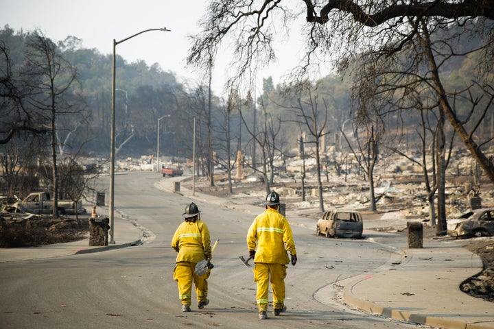 Firefighters walk through the Fountaingrove neighborhood on October 13, 2017 in Santa Rosa, California. (Photo by Elijah Nouvelage/Getty Images)