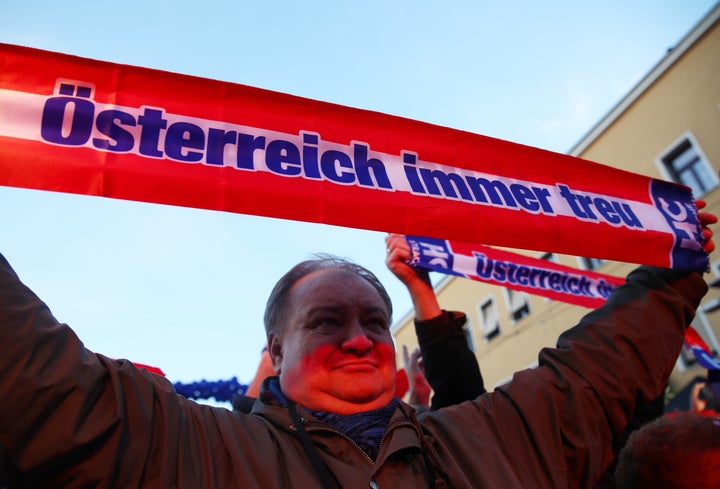 A supporter holds a banner reading "Austria always loyal" during the Austrian Freedom Party's final election campaign rally in Vienna.