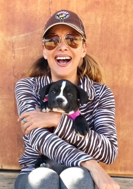 Sky Valencia and Pit Bull puppy Charity. Charity was rescued from being a breeding machine.