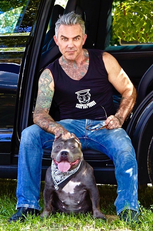 Actor Brandon Liberati poses with rescued Pit Bull Minnie for the anti-dog fighting billboards.