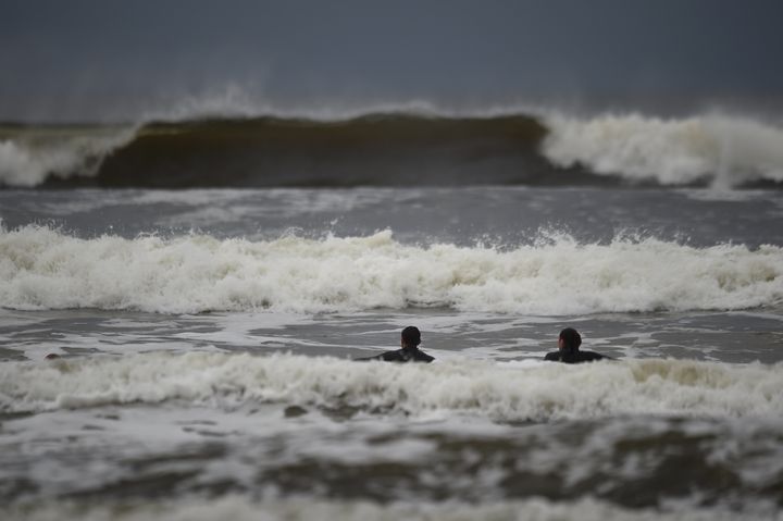Surfers watch as waves approach in the Atlantic on the eve of storm Ophelia in an area where the tide should be out in the County Clare town of Lahinch, Ireland October 15, 2017.