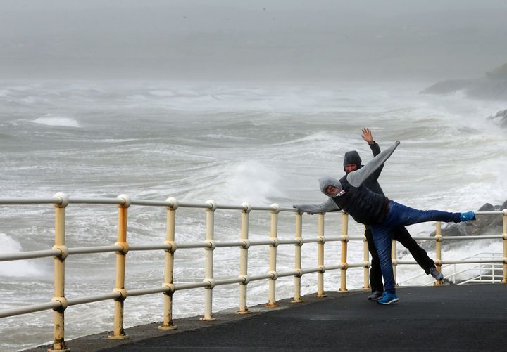 People battle the waves and high wind at Lahinch in County Clare on the West Coast of Ireland