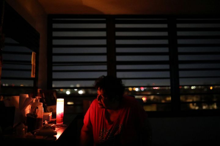 Carmen Correa uses a candle to light up a room at the Moradas Las Teresas Elderly House, where about two hundred elderly people live without electricity following damages caused by Hurricane Maria in Carolina, Puerto Rico, September 30, 2017.