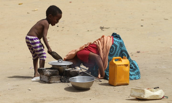 A child helps his mother light a fire in N'djamena, Chad.