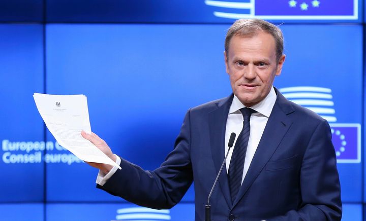 European Council President Donald Tusk shows British Prime Minister Theresa May's letter