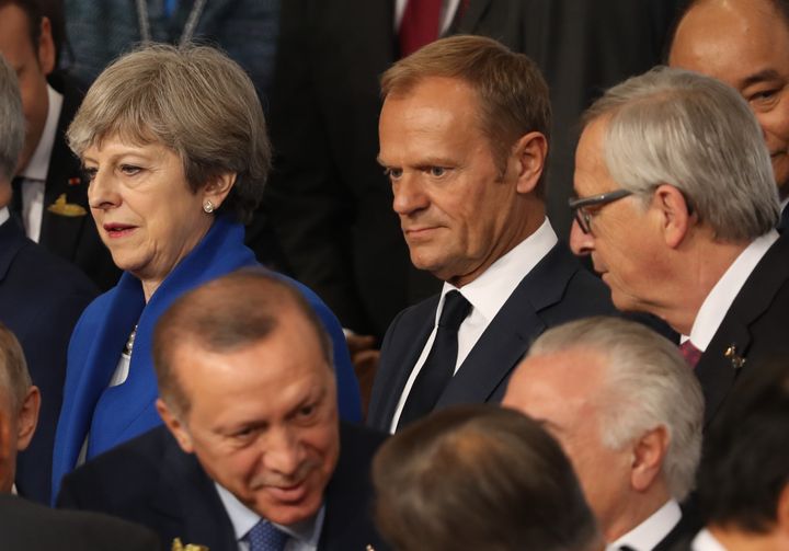 British Prime Minister Theresa May (top left) stands next to Donald Tusk, President of the European Council (C) and President of the EU Commission Jean-Claude Juncker (R