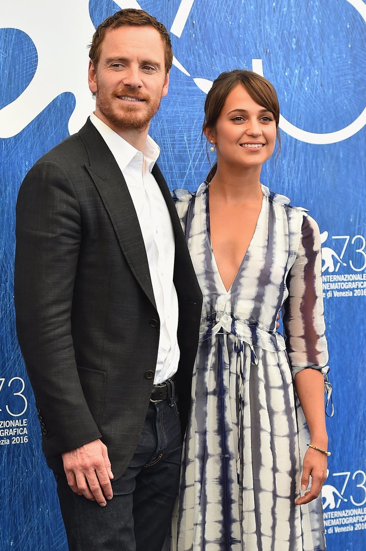 Smitten Alicia Vikander wears white as she shares a kiss with fiance  Michael Fassbender amid reports their wedding is imminent