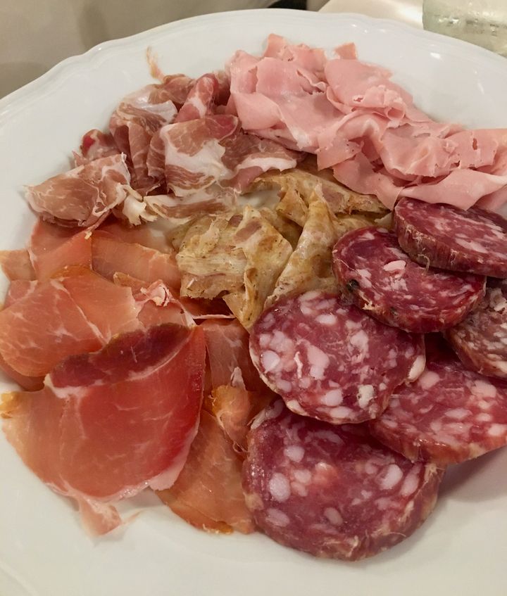 Salumi at Trattoria Pomposa, Modena. The beige slices in the center of the platter are ciccioli