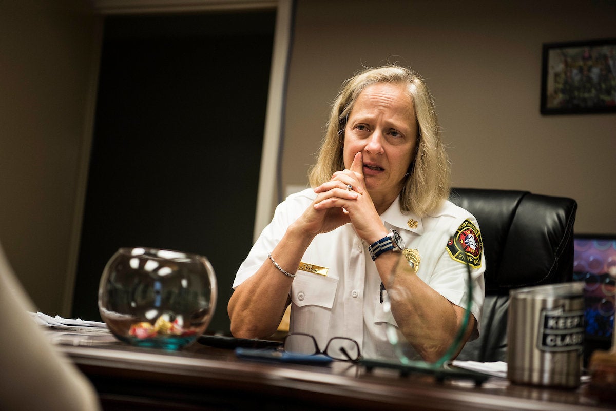 Fire Chief Jan Rader speaks to reporters about the opioid epidemic in her community while sitting in her office in Huntington, West Virginia.