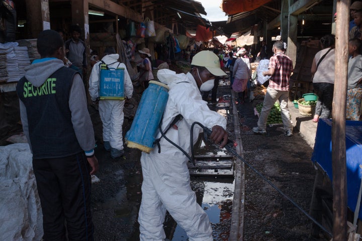 Government workers spray disinfectant during cleanup of a market in Antananarivo, the capital of Madagascar, on Oct. 10.