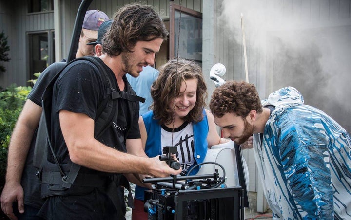<p>Music video director JohnPaul Morris (left) gives Katie Larson (center) and Michael Dause a sneak preview.</p>