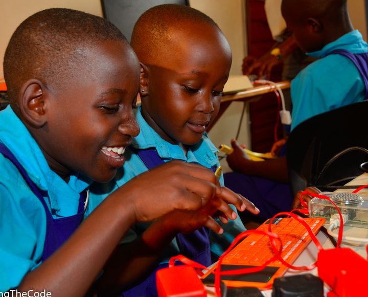 Girls learning to code and build a computer at Theirworld Code Club, Women in Technology Uganda. 