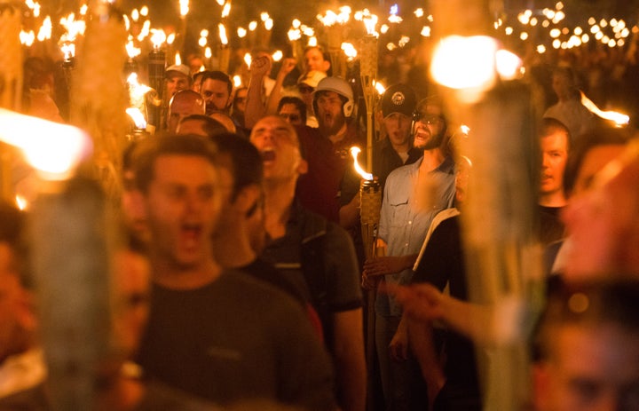 White supremacists march through the University of Virginia campus in Charlottesville on Aug. 11, 2017, the night before holding a violent "Unite The Right" rally.