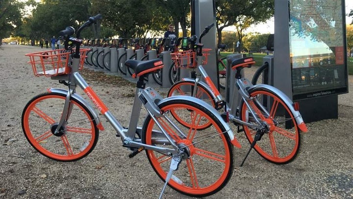 Dockless bikes are parked next to a docking station for Capital Bikeshare, Washington, D.C.’s municipal bike-share program.