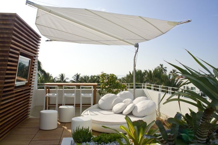 Luxe white daybeds scatter the roof next to the pool and overlook the ocean beyond. Brilliant way to watch the sun go down with friends and a cocktail