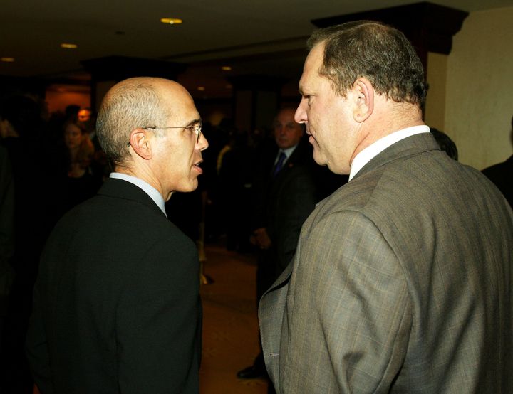 Jeffrey Katzenberg and Harvey Weinstein talk at a charity dinner on Sept. 25, 2003.