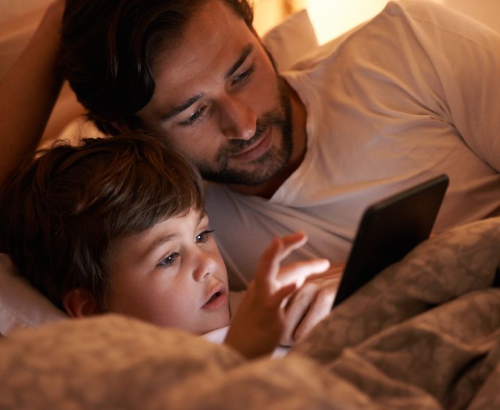 A father and son lying in bed with an e-readerhttp://195.154.178.81/DATA/i_collage/pi/shoots/783045.jpg Yuri_Arcurs via Getty Images