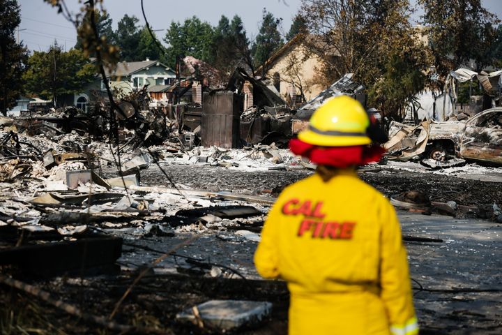 A Cal Fire employee surveys damage in the Coffey Park neighborhood of Santa Rosa on Friday.