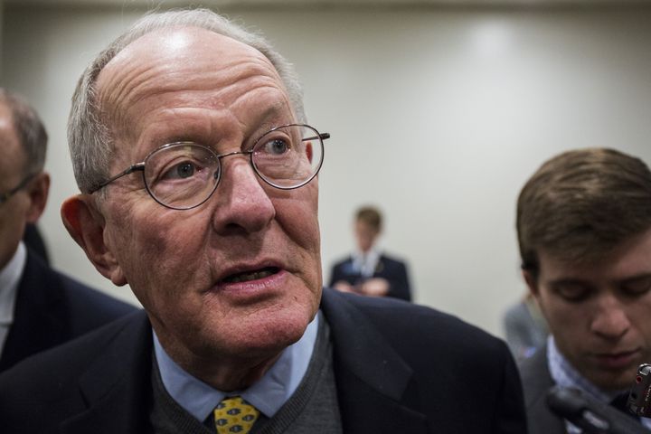 Sen. Lamar Alexander (R-Tenn.) speaks to the media Wednesday while heading to a roll call vote on Capitol Hill.