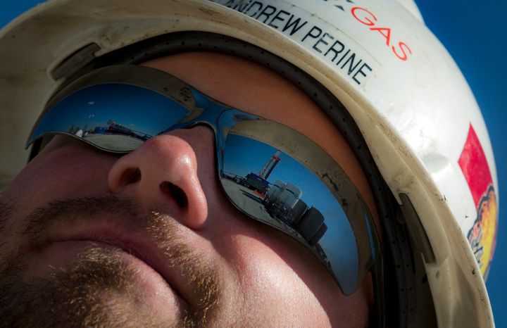 A Consol Energy Horizontal Gas Drilling Rig exploring the Marcellus Shale outside the town of Waynesburg, PA is reflected on worker's sunglasses on April 13, 2012.