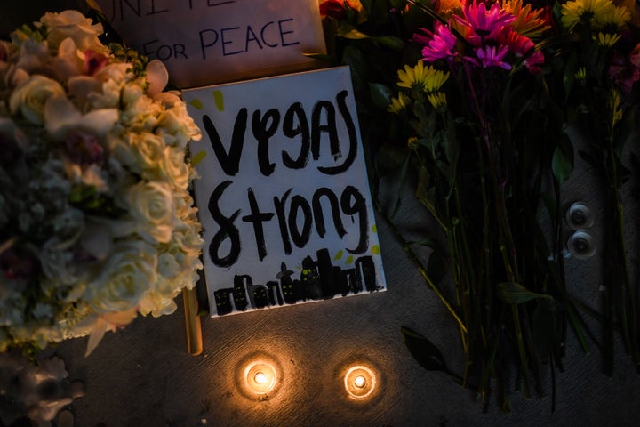 Flowers and signs are seen at a vigil that was held for the victims along the Las Vegas Strip a day after 59 people were killed and more than 500 wounded at the Route 91 Harvest Country Music Festival on Oct. 2.