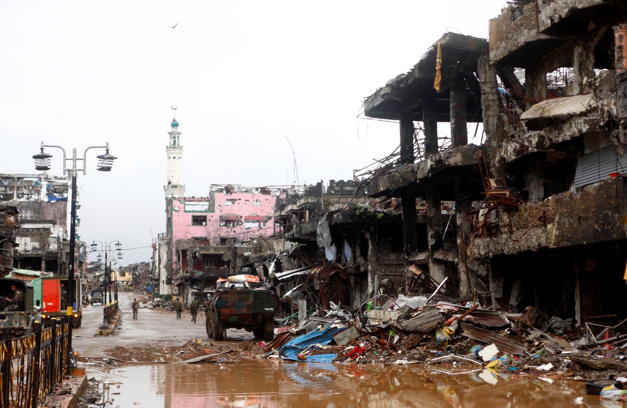 Soldiers walk through a battle damaged street in Marawi City in the Southern Philippines on Oct. 17, 2017.