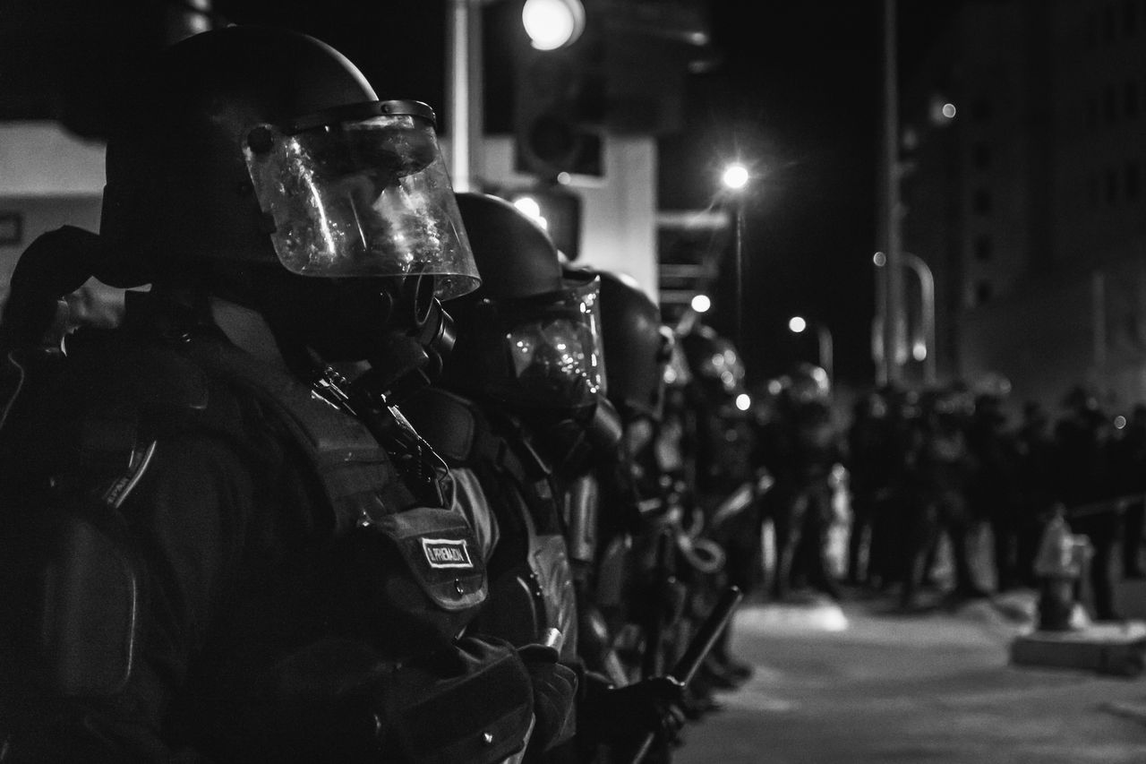 Albuquerque police officers observe a protest in March 2014, just weeks before the U.S. Department of Justice released a scathing report about the department's unconstitutional practices.