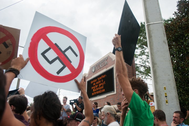 People protest near the Hull Road entrance to University of Florida.